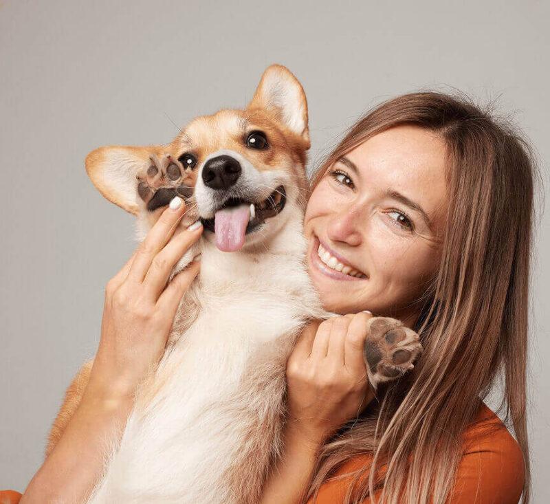 Dog is held by its female owner.
